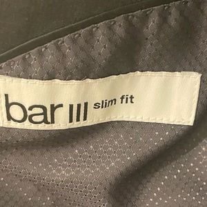 Three piece grey Bar III men slim fit suit. Jacket, pants, and vest.